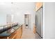 Modern kitchen featuring stainless steel appliances, wooden cabinets, and in-unit laundry at 1401 Delgany St # 211, Denver, CO 80202
