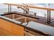 Close-up of a modern kitchen sink with a stainless steel faucet and dark countertop at 1401 Delgany St # 211, Denver, CO 80202