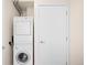 A stacked washer and dryer unit is conveniently located next to a closet and door at 1401 Delgany St # 211, Denver, CO 80202