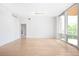 Open living area with hardwood floors, neutral walls and access to a private balcony at 1401 Delgany St # 211, Denver, CO 80202