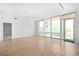 Open living area with hardwood floors, neutral walls and a balcony at 1401 Delgany St # 211, Denver, CO 80202