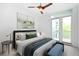 Comfortable bedroom with a ceiling fan, balcony access, and stylish decor at 1401 Delgany St # 211, Denver, CO 80202