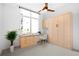 Bright home office features a built-in desk, storage, and a modern ceiling fan at 1401 Delgany St # 211, Denver, CO 80202