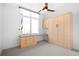 Spare room with murphy bed, desk, and window at 1401 Delgany St # 211, Denver, CO 80202