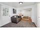 View of the bedroom with a sitting area with a gray couch and view of bedroom at 925 Fulton St, Aurora, CO 80010