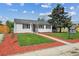Inviting home featuring a lush green lawn, a walkway, and a well-maintained exterior at 925 Fulton St, Aurora, CO 80010