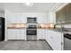 Updated kitchen featuring white cabinets, stainless steel appliances, and ample counter space at 925 Fulton St, Aurora, CO 80010