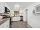 Modern kitchen featuring white cabinets, stainless steel appliances, and a subway tile backsplash at 925 Fulton St, Aurora, CO 80010