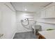 Functional laundry room with utility sink and white cabinets at 925 Fulton St, Aurora, CO 80010