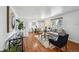 Bright and airy living room featuring hardwood floors, dining area, and neutral decor at 925 Fulton St, Aurora, CO 80010