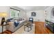 Comfortable living room with a plush sofa, hardwood floors, and a view of the front yard at 925 Fulton St, Aurora, CO 80010