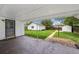 Covered patio and backyard featuring grassy area and storage sheds at 925 Fulton St, Aurora, CO 80010