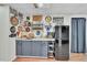 Basement kitchenette with a counter, cabinets, refrigerator, and decor, providing a casual space at 12079 E Louisiana Ave, Aurora, CO 80012