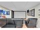 Finished basement featuring a home theater setup with a large projection screen and comfortable seating at 12079 E Louisiana Ave, Aurora, CO 80012