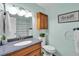 Bathroom with a modern vanity, a tiled shower, and brushed nickel fixtures at 12079 E Louisiana Ave, Aurora, CO 80012
