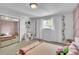 Bedroom with pink accent wall, plush carpet, a window, closet, and floral accents at 12079 E Louisiana Ave, Aurora, CO 80012