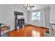 Bedroom with wood floors, a ceiling fan, and a window overlooking outdoor play equipment at 12079 E Louisiana Ave, Aurora, CO 80012