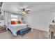 Bright bedroom featuring a ceiling fan, carpet floors, and white walls at 12079 E Louisiana Ave, Aurora, CO 80012
