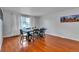 Cozy dining room featuring hardwood floors and a large window for natural light at 12079 E Louisiana Ave, Aurora, CO 80012