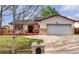 Charming ranch-style home featuring a well-manicured lawn and a spacious two-car garage at 12079 E Louisiana Ave, Aurora, CO 80012