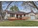 Quaint ranch-style home with a welcoming front porch and lush green lawn at 12079 E Louisiana Ave, Aurora, CO 80012