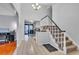 Bright foyer with tile flooring, staircase, and open view to the dining area at 12079 E Louisiana Ave, Aurora, CO 80012