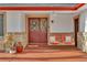 Close-up of front porch showing the swing, entry door, and decorative plants at 12079 E Louisiana Ave, Aurora, CO 80012