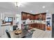 Kitchen featuring dark cabinets, stainless steel appliances, and a tile backsplash at 12079 E Louisiana Ave, Aurora, CO 80012