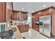 Traditional eat-in kitchen with stainless steel appliances, granite counters, and ample cabinet space at 12079 E Louisiana Ave, Aurora, CO 80012