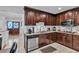 Eat-in kitchen featuring stainless steel appliances, tile backsplash, granite countertops, and wooden cabinets at 12079 E Louisiana Ave, Aurora, CO 80012