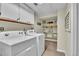 Functional laundry room with shelving, a washer, and a dryer at 12079 E Louisiana Ave, Aurora, CO 80012