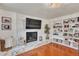 Bright living room with a modern fireplace and built-in shelves at 12079 E Louisiana Ave, Aurora, CO 80012