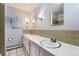 Bathroom with double sink vanity, tiled walls, and decorative mirror at 9451 E Evans Pl, Denver, CO 80231