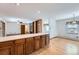 Open kitchen with wooden cabinets and a view into the living and dining areas at 9451 E Evans Pl, Denver, CO 80231