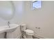Bathroom featuring a modern white vanity with a round mirror and white toilet at 657 Harness St, Erie, CO 80516