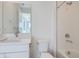 Bright bathroom featuring white cabinetry, quartz countertop, and walk-in shower at 657 Harness St, Erie, CO 80516
