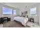 Bedroom featuring a large bed, two windows, and a rug at 657 Harness St, Erie, CO 80516