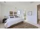 Bedroom featuring a large bed, art pieces, and view of bathroom at 657 Harness St, Erie, CO 80516