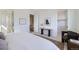 Bedroom featuring a large bed, black chair, and view of the staircase at 657 Harness St, Erie, CO 80516