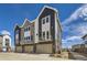 Modern townhome exterior with gray siding and attached garage and balconies at 657 Harness St, Erie, CO 80516