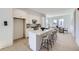 Modern kitchen with white cabinets, quartz countertops, an island with bar seating, and stainless steel appliances at 657 Harness St, Erie, CO 80516