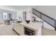 Kitchen island featuring white cabinets and marble countertop. Also a staircase at 657 Harness St, Erie, CO 80516
