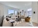 Bright living room features modern furniture, stylish decor, light wood floors, and large windows with neighborhood views at 657 Harness St, Erie, CO 80516