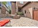Inviting backyard with stone patio, built-in fire pit, outdoor kitchen, and comfortable seating at 8053 E Maple Ave, Denver, CO 80230