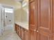 Well-lit bathroom showcasing a double sink vanity, tiled floors, and a separate shower at 8053 E Maple Ave, Denver, CO 80230