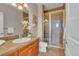 Bathroom features a glass-enclosed shower and vanity with stylish countertops and a large decorative mirror at 8053 E Maple Ave, Denver, CO 80230