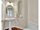 Charming powder room featuring a pedestal sink and elegant fixtures at 8053 E Maple Ave, Denver, CO 80230