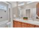 Bright bathroom featuring double sinks, spacious countertop, and shower-tub combination with modern fixtures at 8053 E Maple Ave, Denver, CO 80230