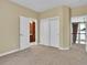 Neutral bedroom with 3 doorways and a closet at 8053 E Maple Ave, Denver, CO 80230