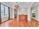 Dining area featuring hardwood floors, chandelier, and view to kitchen at 8053 E Maple Ave, Denver, CO 80230